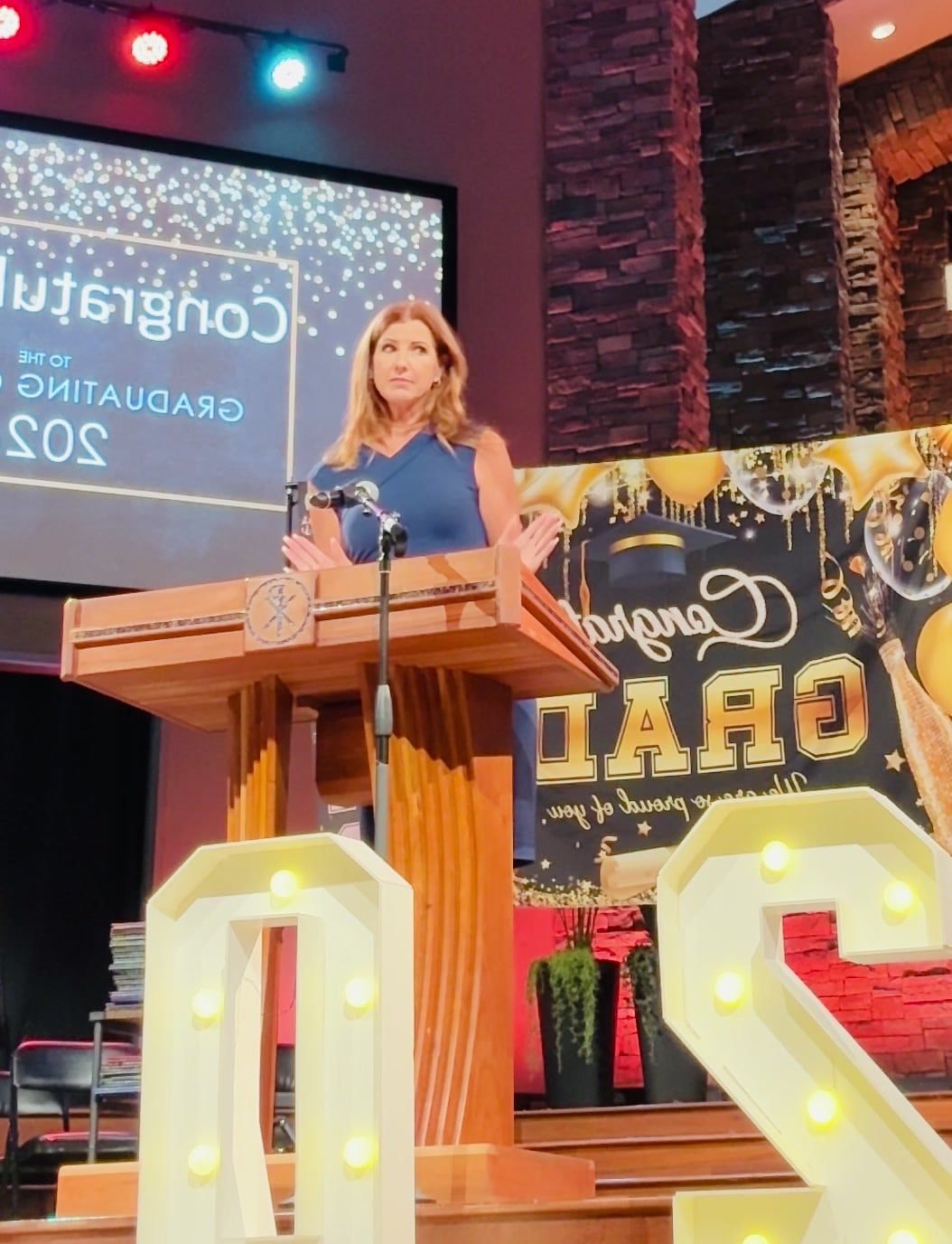 Suzanne Hobbs speaking from a podium at a high school graduation in Las Vegas.