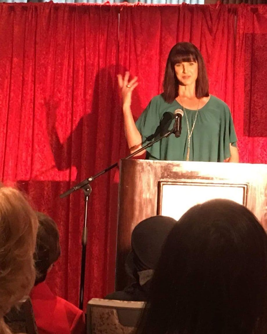 Suzanne Hobbs speaking about Safe Haven at a podium in Pittsburgh.
