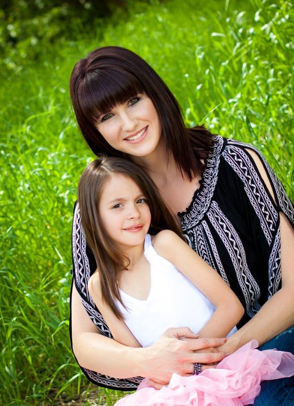 Suzanne Hobbs outdoors with Lillie, aged about eight.