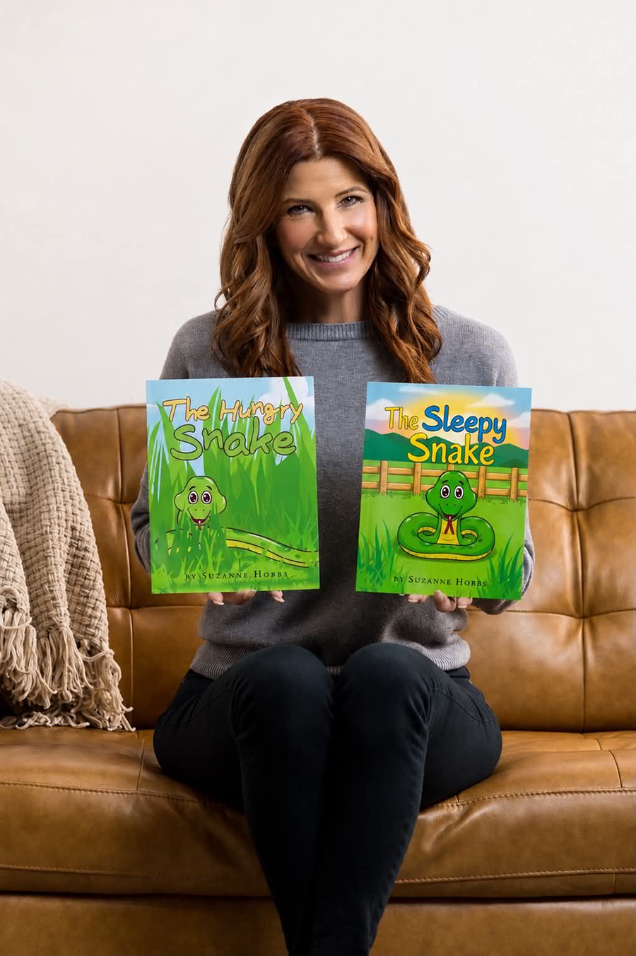 Suzanne Hobbs with her books, The Sleepy Snake and The Hungry Snake.